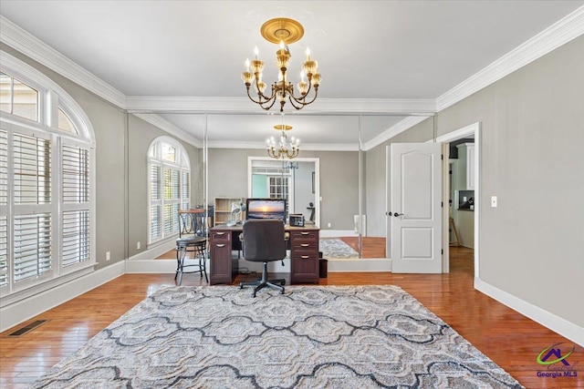 home office with an inviting chandelier, ornamental molding, and light hardwood / wood-style floors