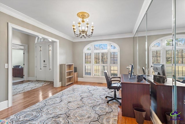 office with light wood-type flooring, a notable chandelier, and ornamental molding