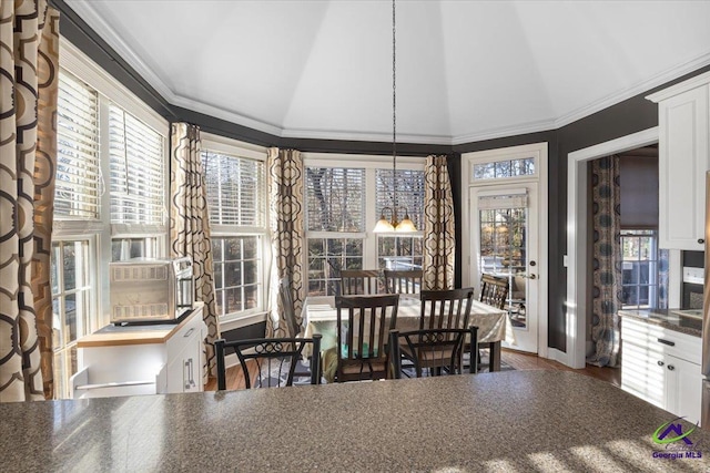 sunroom featuring vaulted ceiling and a wealth of natural light