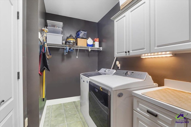 washroom with cabinets, light tile patterned flooring, and separate washer and dryer