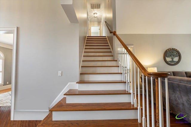 stairway with hardwood / wood-style flooring