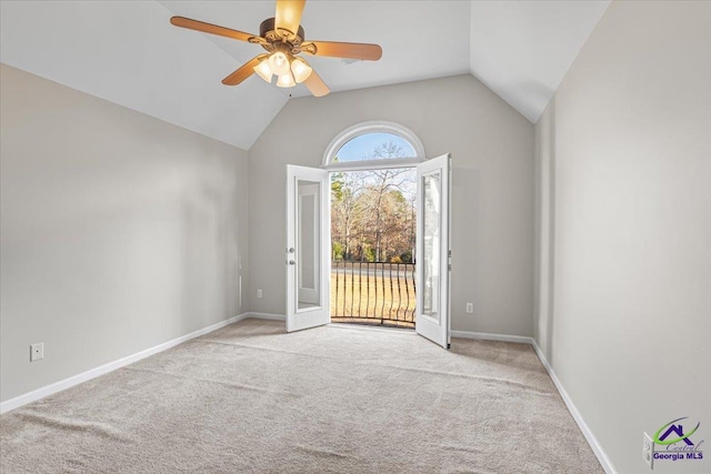 carpeted empty room featuring ceiling fan, french doors, and lofted ceiling