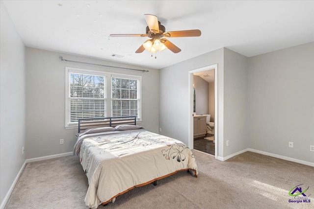 bedroom with ceiling fan, connected bathroom, and carpet floors