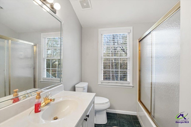 full bathroom featuring toilet, vanity, tile patterned flooring, and enclosed tub / shower combo