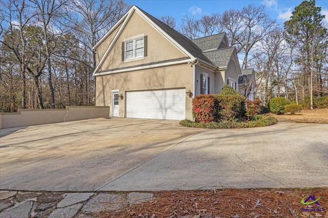 view of side of home featuring a garage