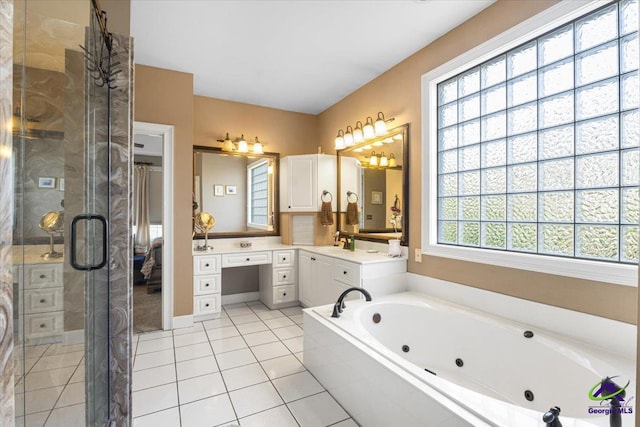 bathroom with tile patterned flooring, shower with separate bathtub, and vanity