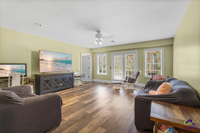 living room with dark wood-type flooring and ceiling fan