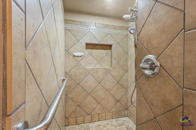 bathroom with a tile shower