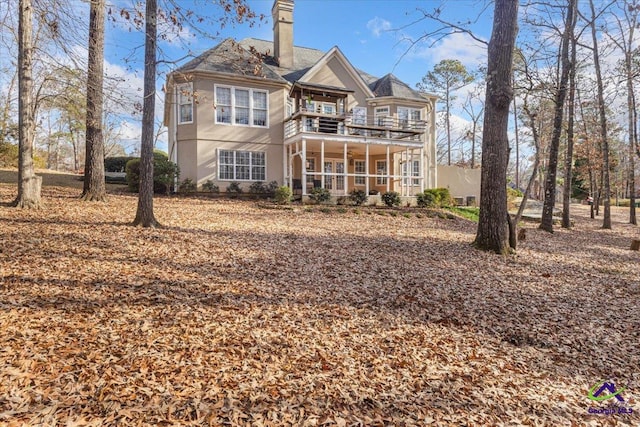 rear view of property featuring a balcony