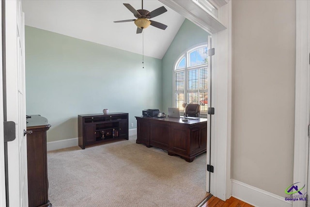 carpeted office featuring ceiling fan and vaulted ceiling