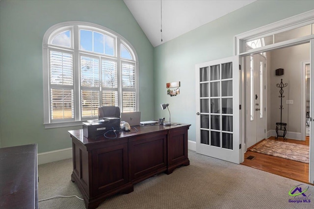 office space featuring light colored carpet and lofted ceiling