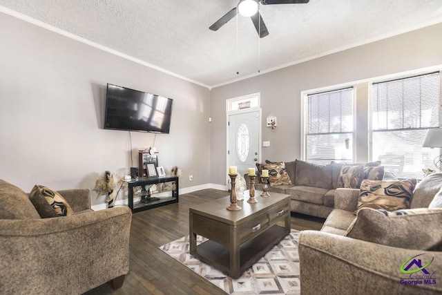 living room featuring a textured ceiling, ceiling fan, dark hardwood / wood-style flooring, and crown molding