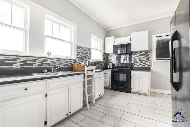 kitchen with black appliances, sink, crown molding, and white cabinetry