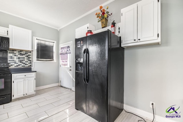 kitchen with white cabinets, black appliances, and crown molding