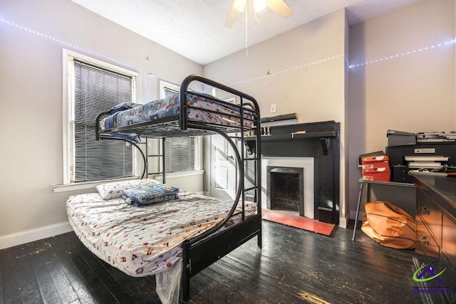 bedroom with ceiling fan and dark hardwood / wood-style flooring