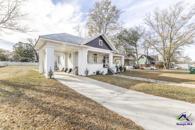 view of front of property with covered porch and a front lawn