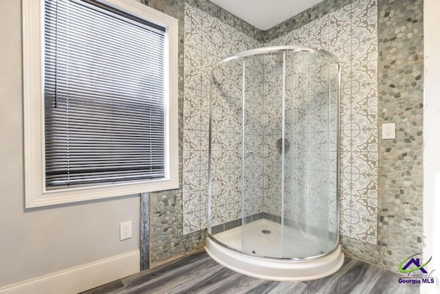 bathroom featuring hardwood / wood-style floors and a shower with door