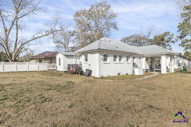 rear view of property featuring a lawn