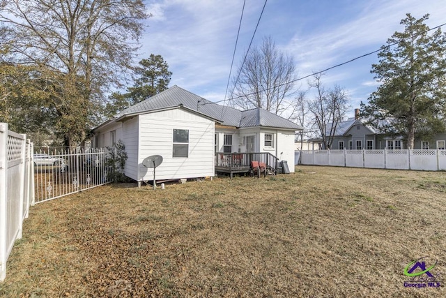 rear view of property featuring a yard