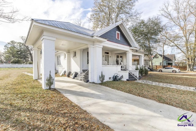 view of side of property featuring a yard and a porch