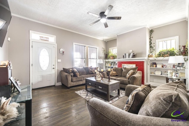 living room with a textured ceiling, ceiling fan, crown molding, and dark wood-type flooring