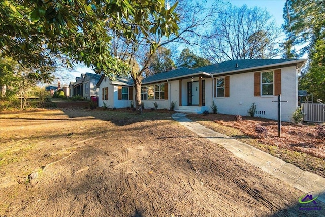 single story home with a front lawn and central air condition unit