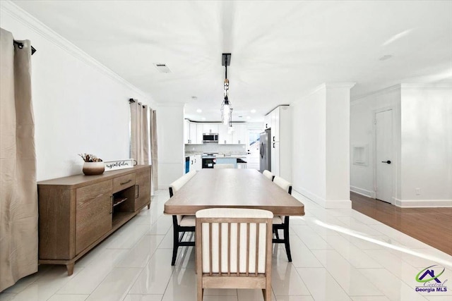 tiled dining room with ornamental molding