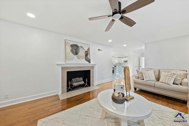 living room featuring ceiling fan and wood-type flooring