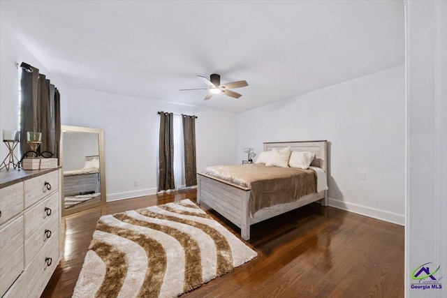 bedroom with ceiling fan and dark wood-type flooring