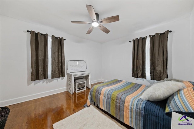 bedroom featuring ceiling fan and dark hardwood / wood-style flooring