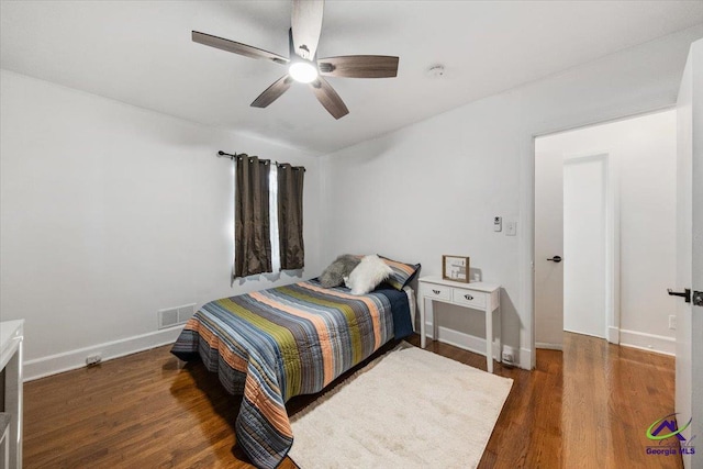 bedroom with dark wood-type flooring and ceiling fan