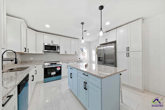 kitchen featuring sink, white cabinetry, a center island, and stainless steel appliances