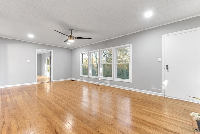 unfurnished living room with a textured ceiling, ceiling fan, ornamental molding, and light wood-type flooring