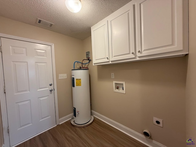 laundry area featuring hookup for a washing machine, water heater, dark hardwood / wood-style flooring, electric dryer hookup, and cabinets