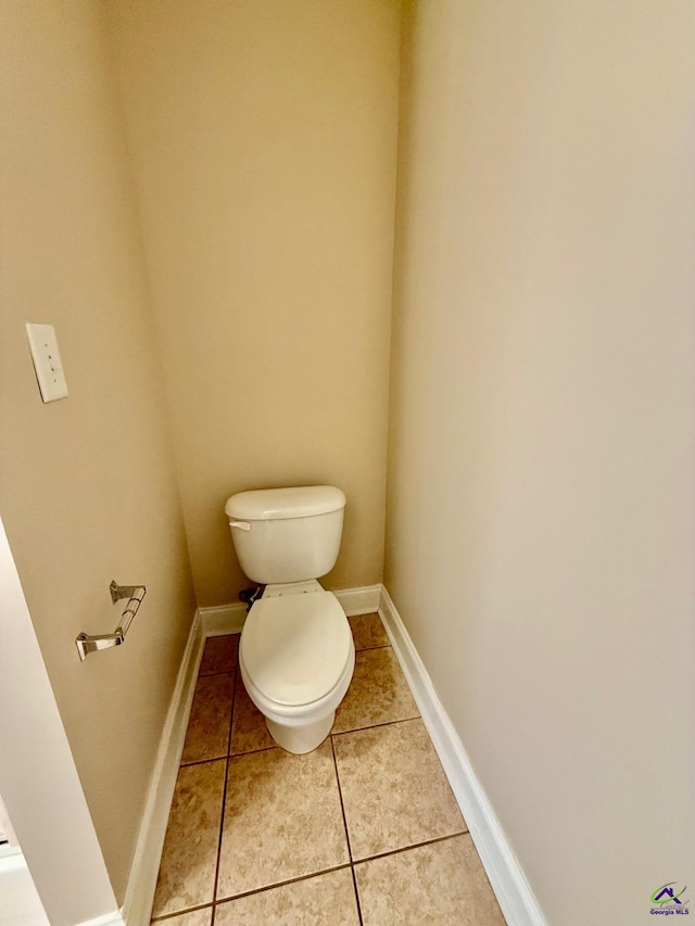 bathroom featuring toilet and tile patterned floors