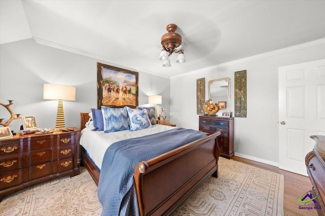 bedroom with ceiling fan, light hardwood / wood-style flooring, and ornamental molding