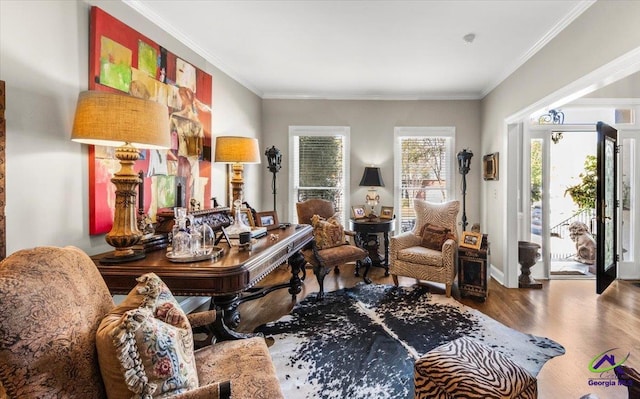 living area featuring hardwood / wood-style floors and crown molding