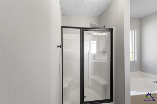 bathroom with a textured ceiling and plus walk in shower