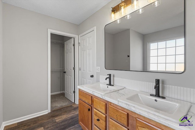 bathroom featuring wood-type flooring, a textured ceiling, and vanity