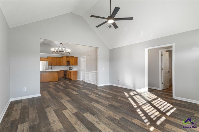 unfurnished living room with high vaulted ceiling, dark hardwood / wood-style floors, and ceiling fan with notable chandelier