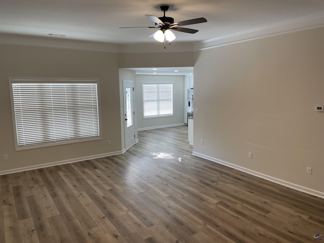 spare room with ceiling fan, ornamental molding, and dark hardwood / wood-style floors