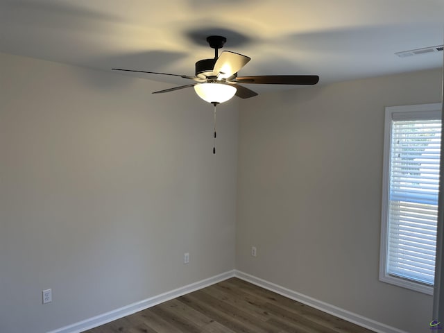 spare room with ceiling fan and dark hardwood / wood-style flooring