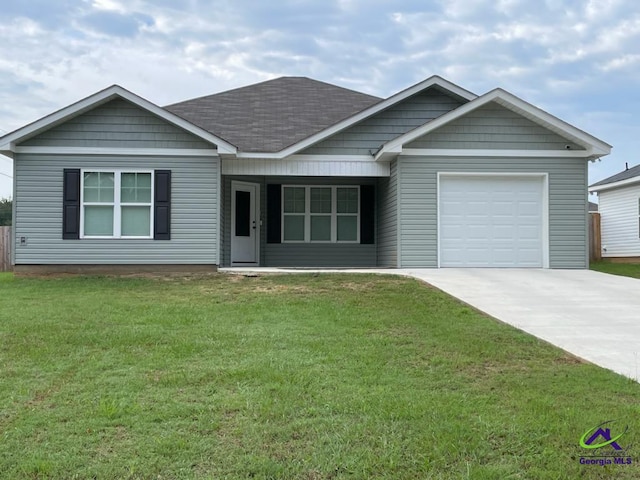 view of front of home featuring a garage and a front lawn