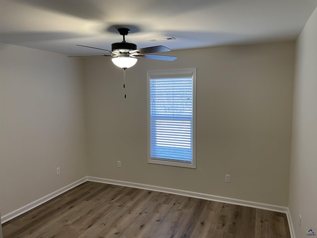 spare room with ceiling fan and wood-type flooring