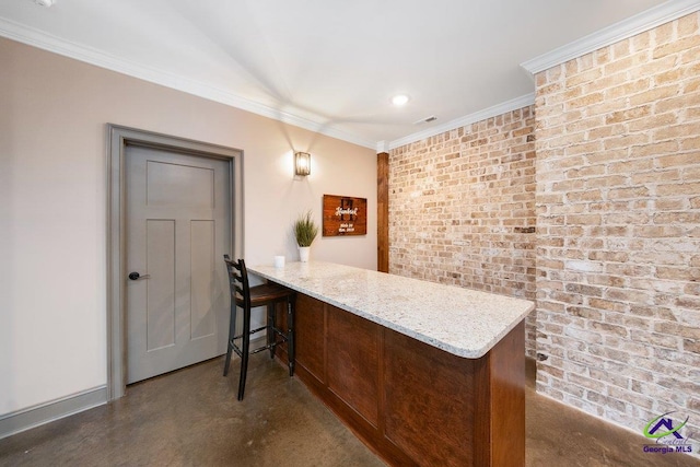 bar with crown molding, brick wall, concrete flooring, and light stone countertops