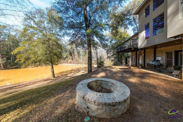 view of yard with a fire pit and a patio area