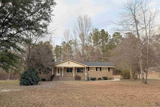 ranch-style home with a front yard and a porch