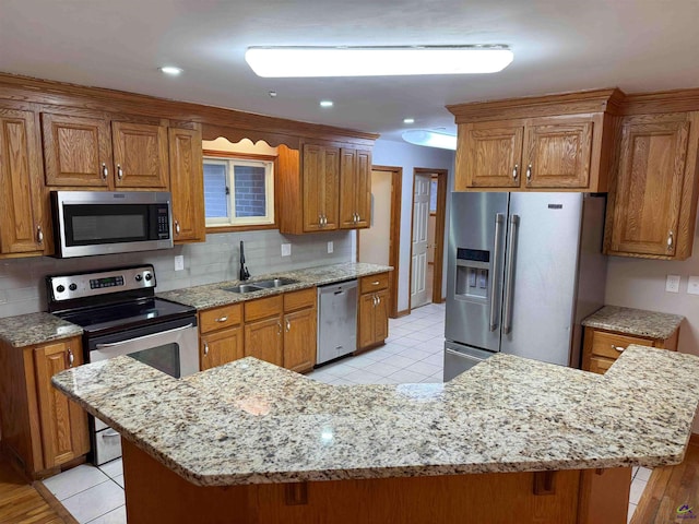 kitchen featuring light tile patterned floors, stainless steel appliances, decorative backsplash, and sink