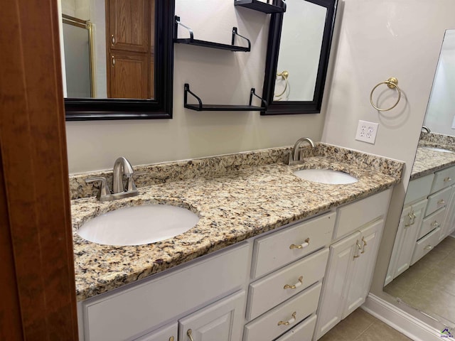 bathroom featuring tile patterned flooring and vanity