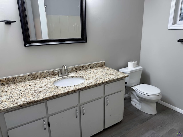 bathroom featuring hardwood / wood-style floors, toilet, and vanity